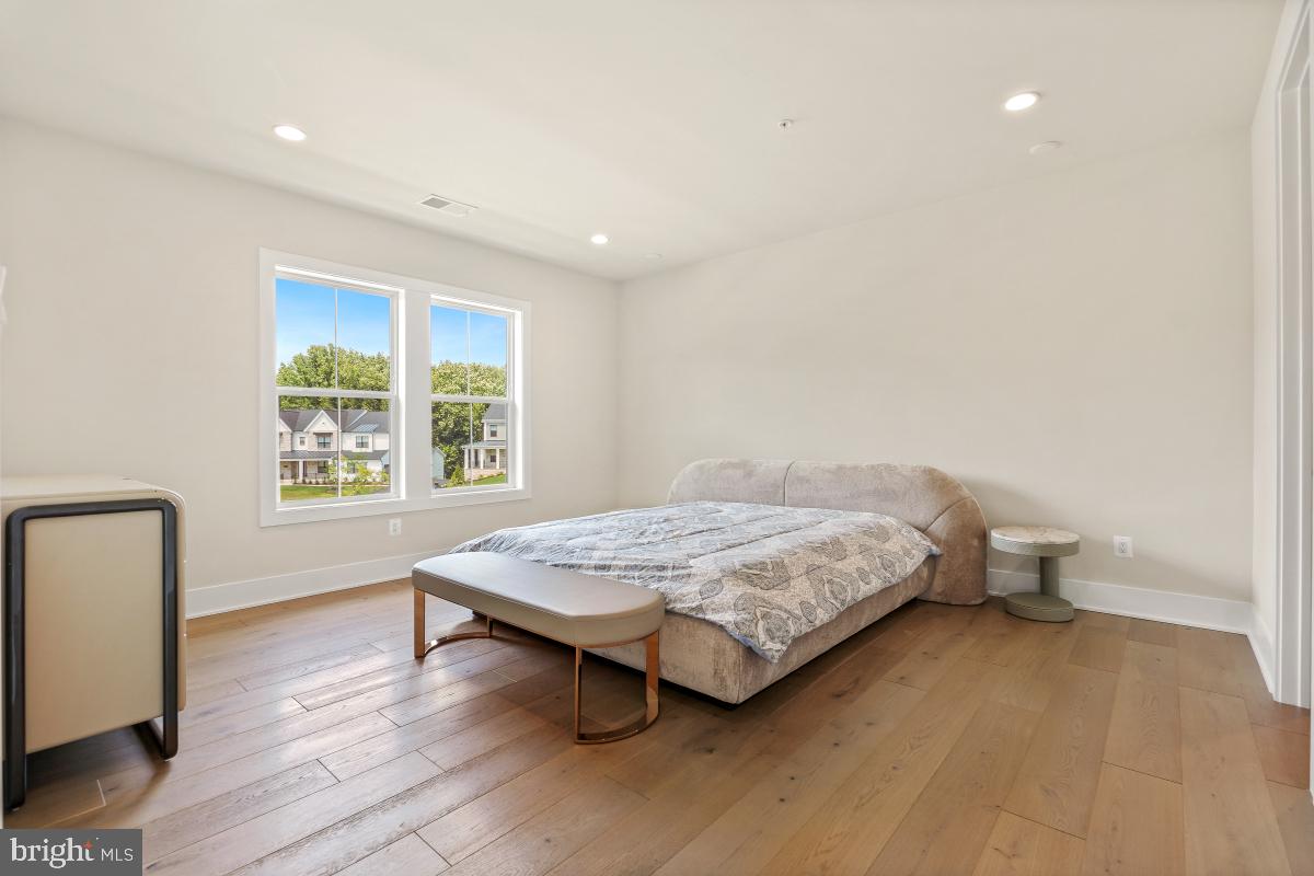 12321 Potomac Hunt Road North Potomac, MD 20878 - Photo 51 of 64 a bedroom with a bed and wooden floor