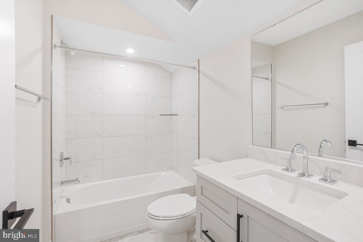 12321 Potomac Hunt Road North Potomac, MD 20878 - Photo 54 of 64 a bathroom with a bathtub shower sink vanity mirror and toilet