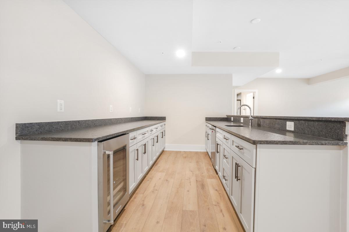 12321 Potomac Hunt Road North Potomac, MD 20878 - Photo 55 of 64 a kitchen with granite countertop a sink and a stove top oven