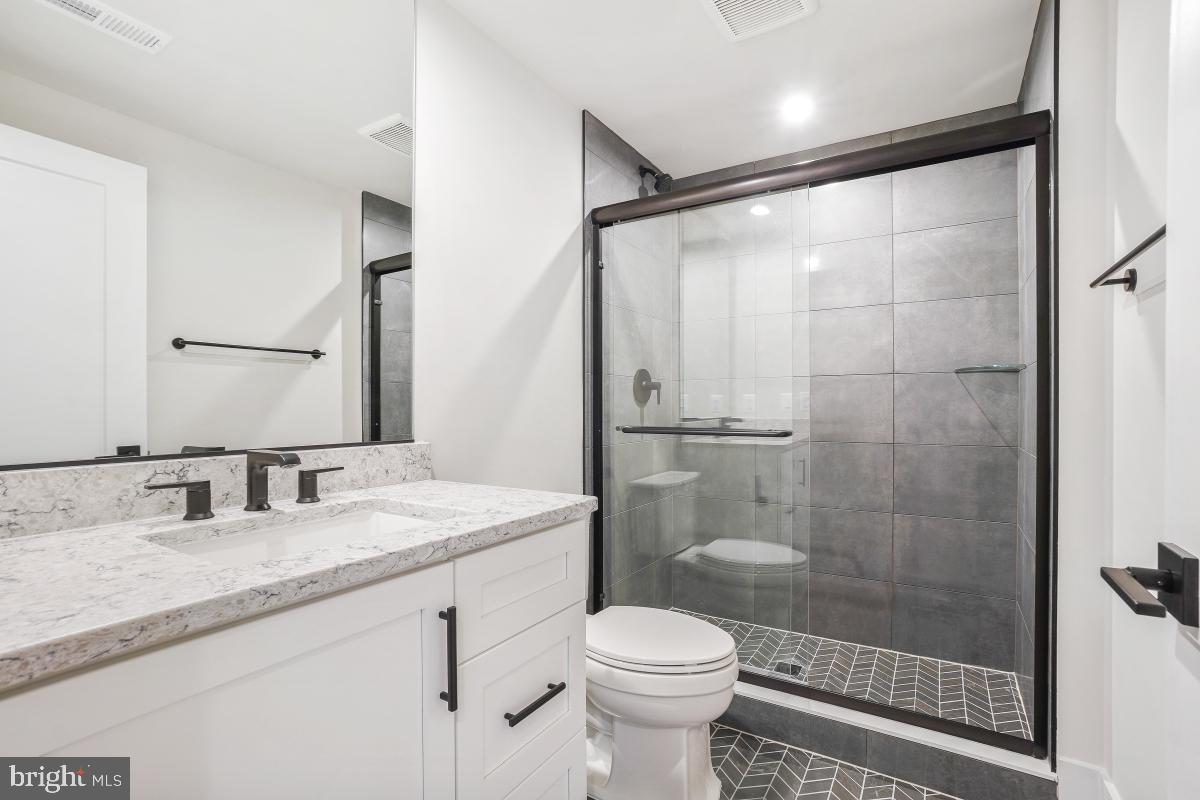 12321 Potomac Hunt Road North Potomac, MD 20878 - Photo 58 of 64 a bathroom with a granite countertop sink toilet and shower