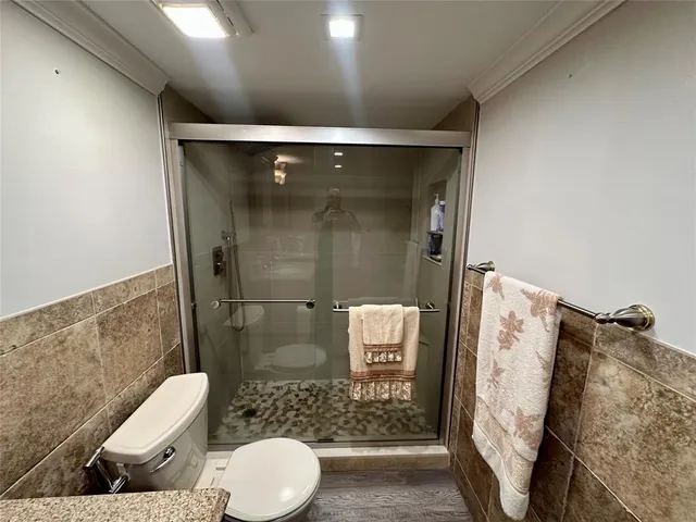 a bathroom with a toilet and a shower