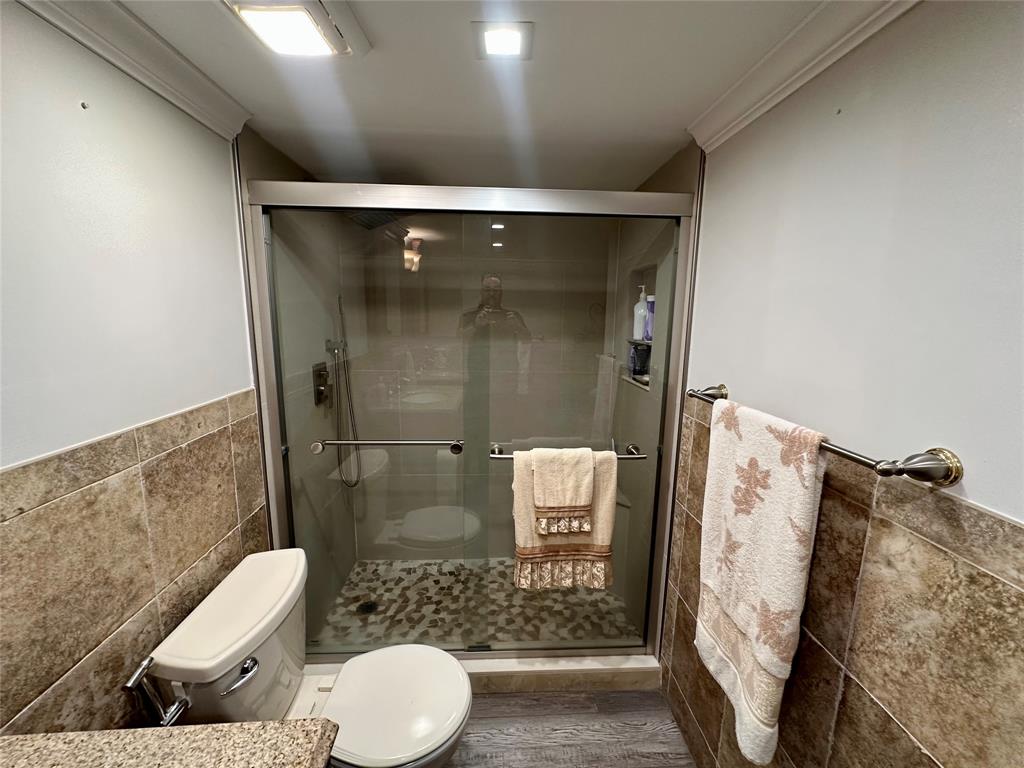 1012 North Ocean Boulevard, Unit 1206 Pompano Beach, FL 33062 - Photo 13 of 33 a bathroom with a toilet and a shower