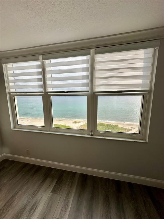 1012 North Ocean Boulevard, Unit 1206 Pompano Beach, FL 33062 - Photo 14 of 33 a view of empty room with wooden floor and fan