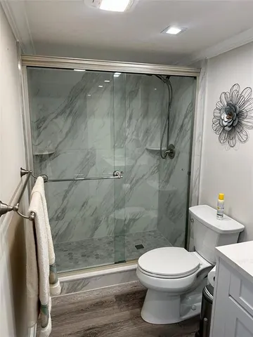 a bathroom with a toilet and a shower