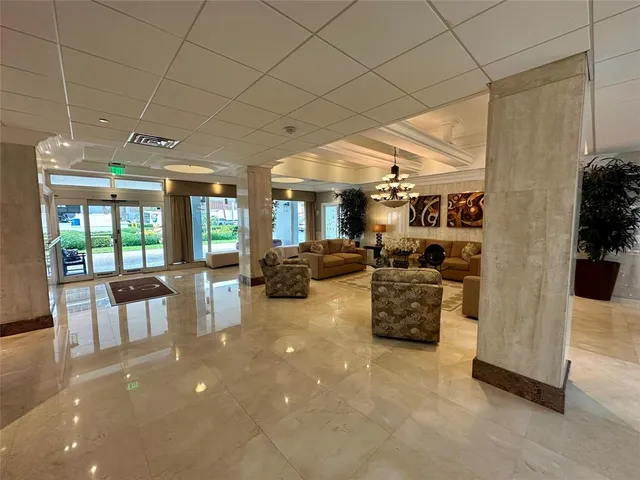 a very nice looking room with a large mirror and chandelier