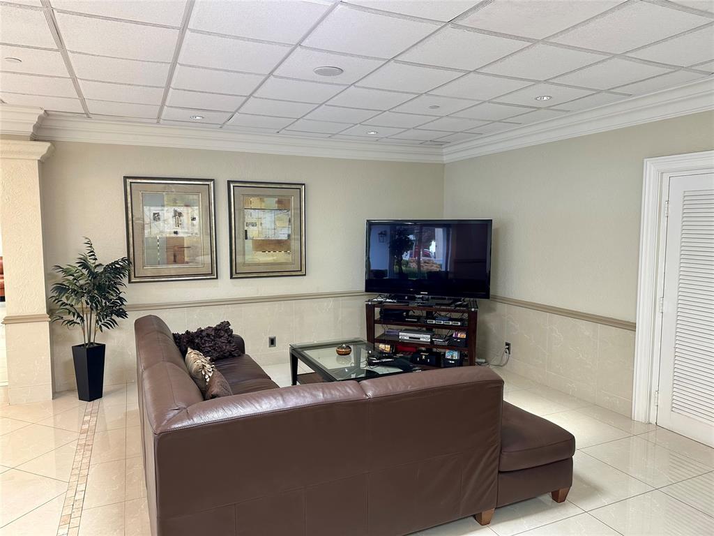 1012 North Ocean Boulevard, Unit 1206 Pompano Beach, FL 33062 - Photo 28 of 33 a living room with furniture and a flat screen tv