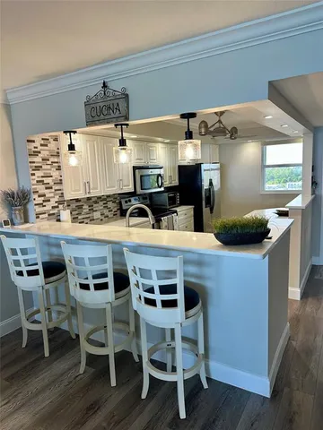 a kitchen with a table and chairs in it