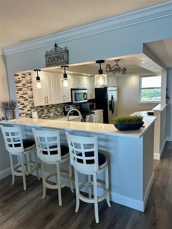 1012 North Ocean Boulevard, Unit 1206 Pompano Beach, FL 33062 - Photo 3 of 33 a kitchen with a table and chairs in it