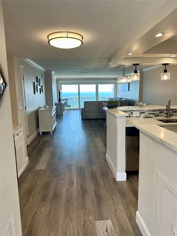 1012 North Ocean Boulevard, Unit 1206 Pompano Beach, FL 33062 - Photo 5 of 33 a kitchen with a stove a refrigerator a sink dishwasher with wooden floor and cabinets