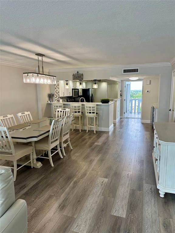 1012 North Ocean Boulevard, Unit 1206 Pompano Beach, FL 33062 - Photo 6 of 33 a dining room with furniture and wooden floor