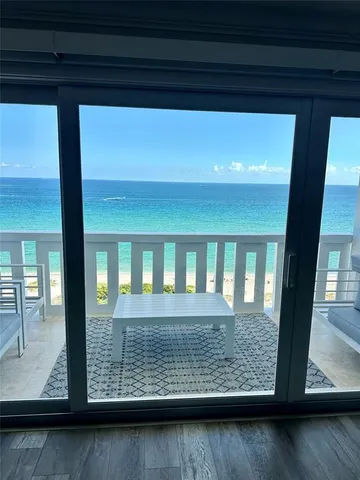 a view of wooden floor and a window