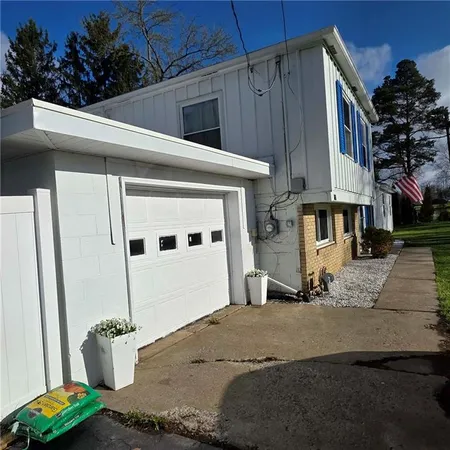 a bedroom with a bed a large window with bed and dresser