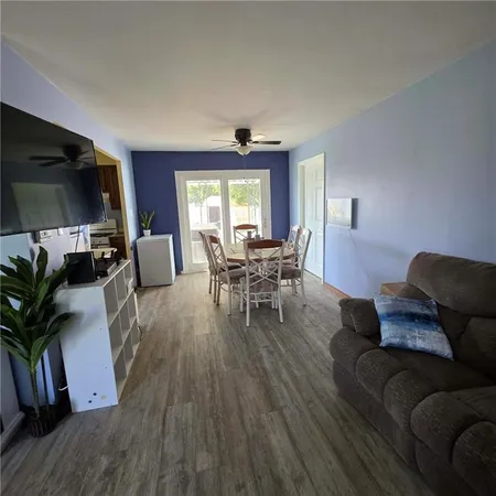 a backyard of a house with table and chairs