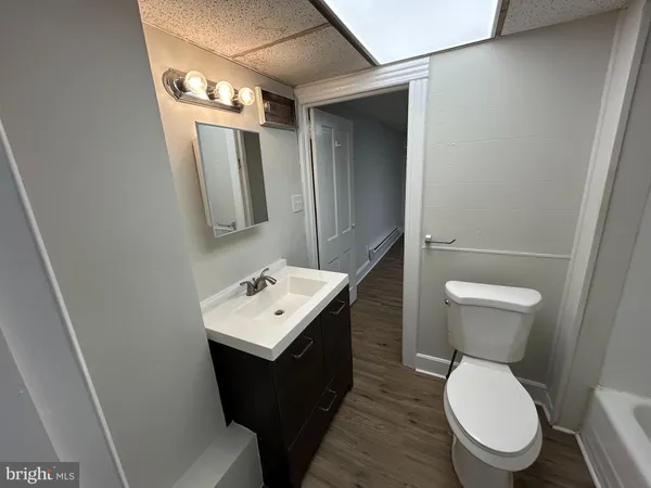 a bathroom with a toilet sink and mirror