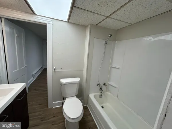 a bathroom with a toilet a sink and bathtub