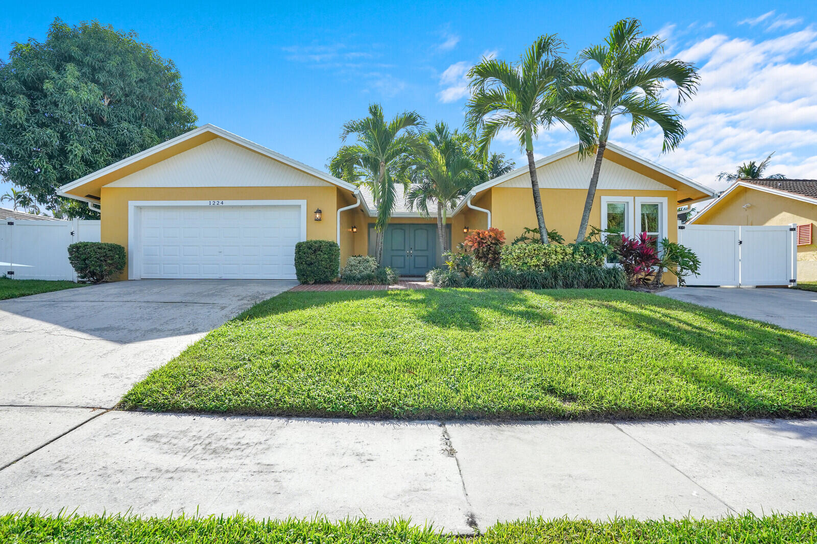 a front view of house with yard and green space