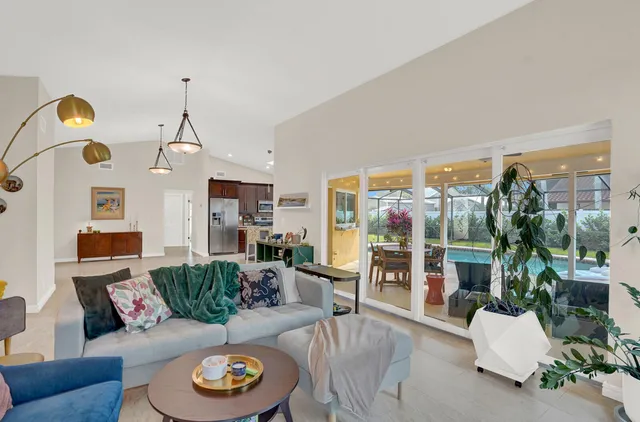 a living room with furniture and a floor to ceiling window