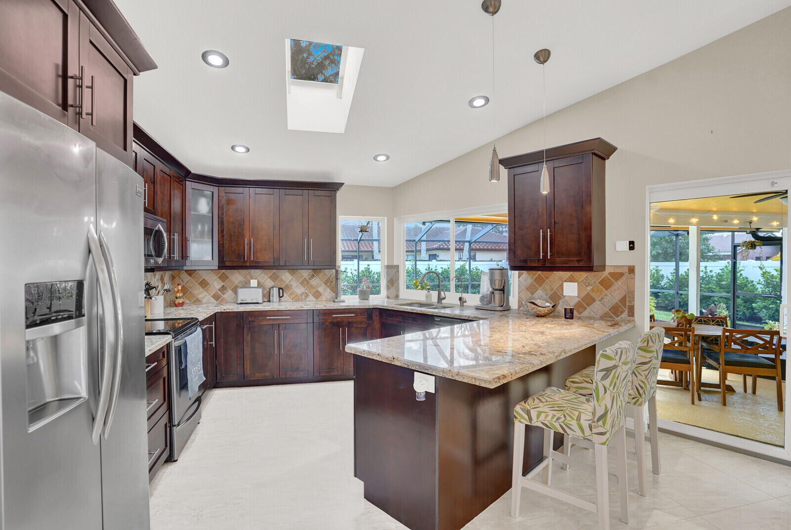1224 Northwest 15th Street Boca Raton, FL 33486 - Photo 15 of 46 a kitchen with stainless steel appliances granite countertop a sink a stove and a refrigerator