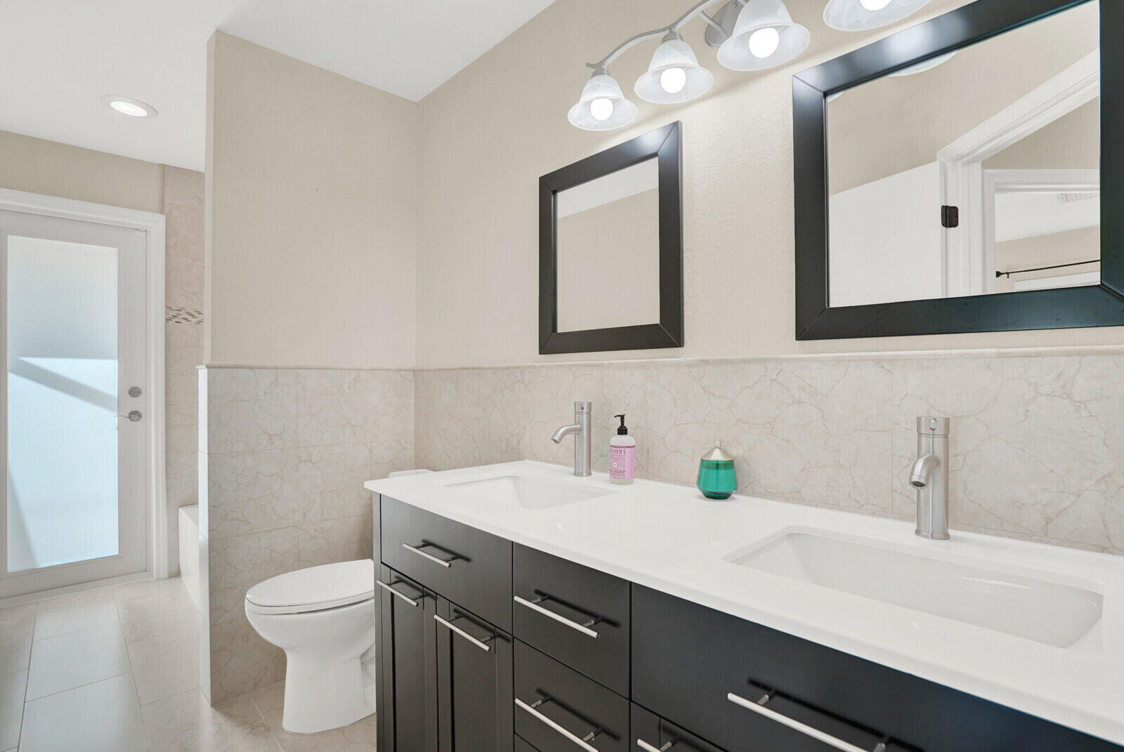 1224 Northwest 15th Street Boca Raton, FL 33486 - Photo 21 of 46 a bathroom with a sink a toilet and mirror