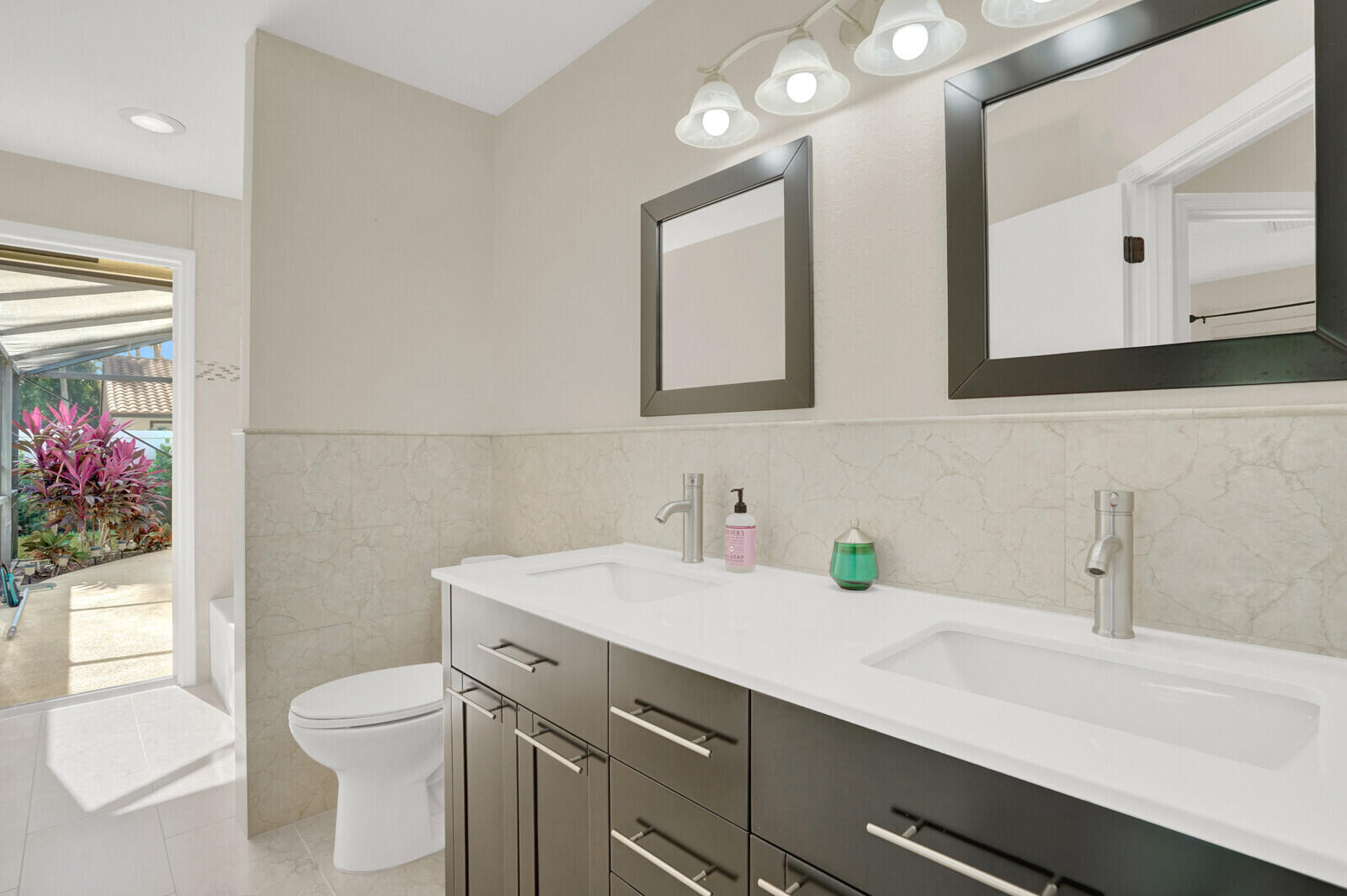 1224 Northwest 15th Street Boca Raton, FL 33486 - Photo 22 of 46 a bathroom with a toilet sink and mirror