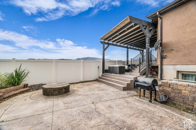 12992 West Geronimo Road Riverton, UT 84096 - Photo 23 of 25 Stamped concrete patio with an integrated fire pit