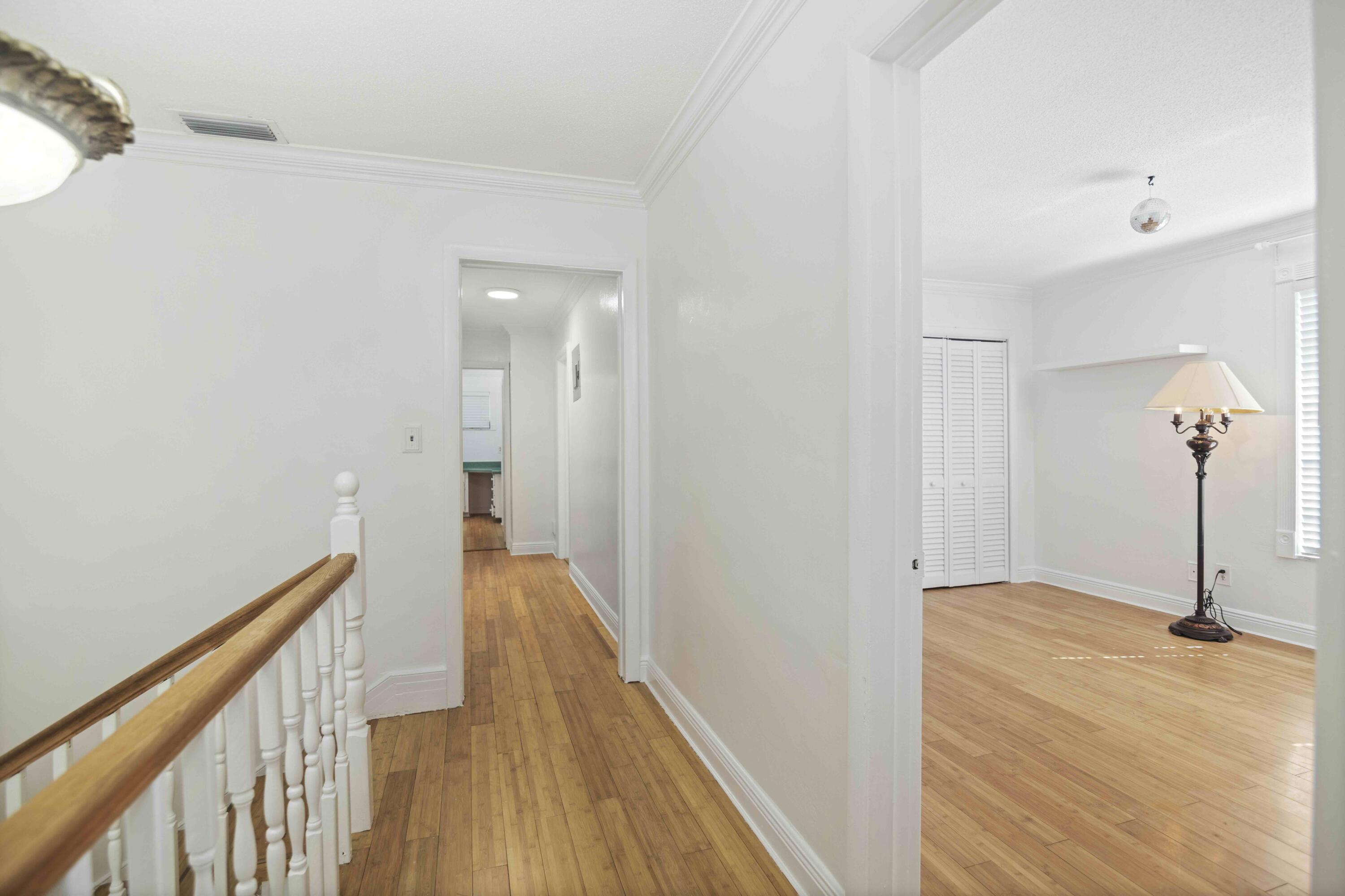 1545 Miami Road Fort Lauderdale, FL 33316 - Photo 20 of 39 a view of a hallway with wooden floor and staircase