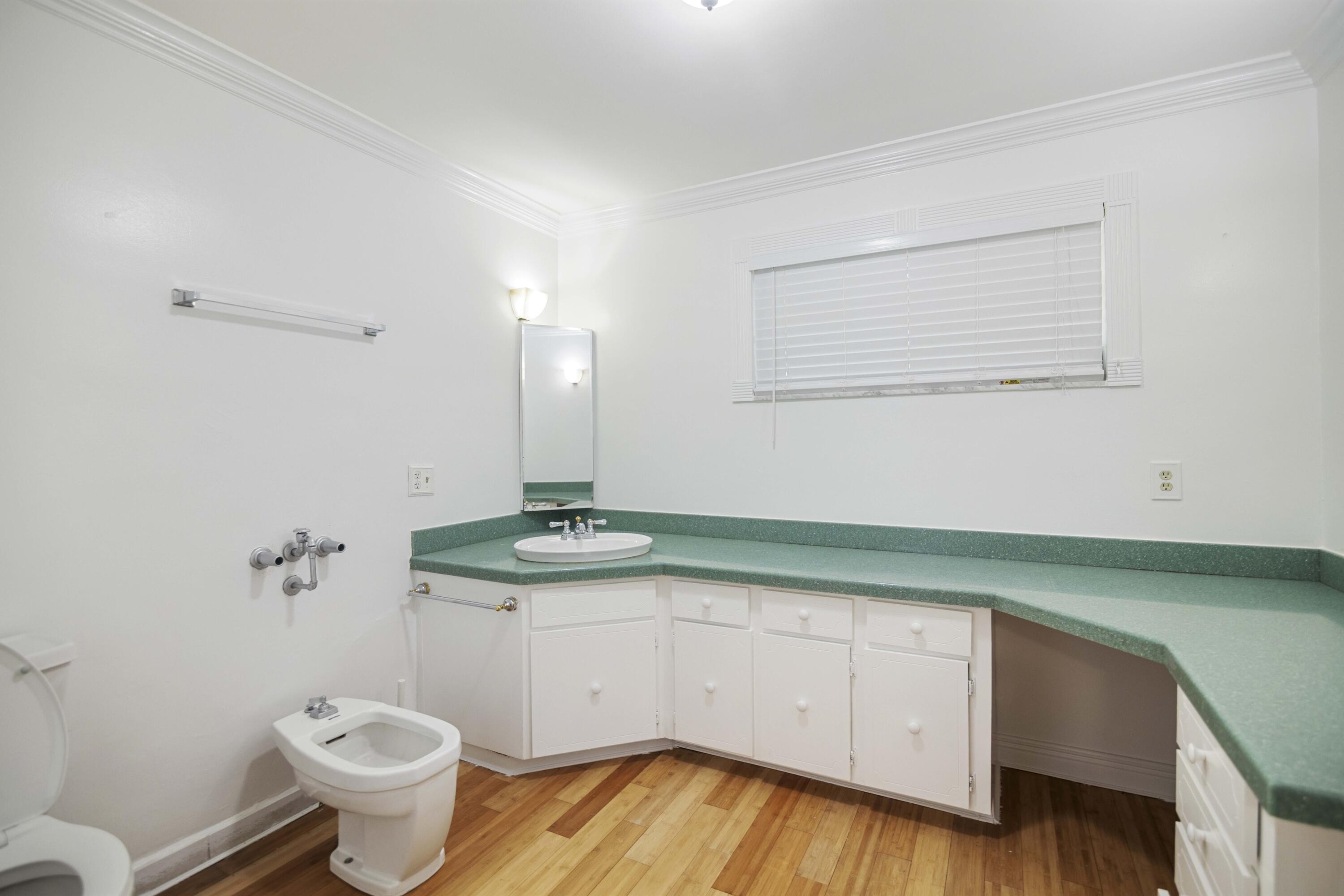 1545 Miami Road Fort Lauderdale, FL 33316 - Photo 22 of 39 a bathroom with a granite countertop toilet sink and mirror