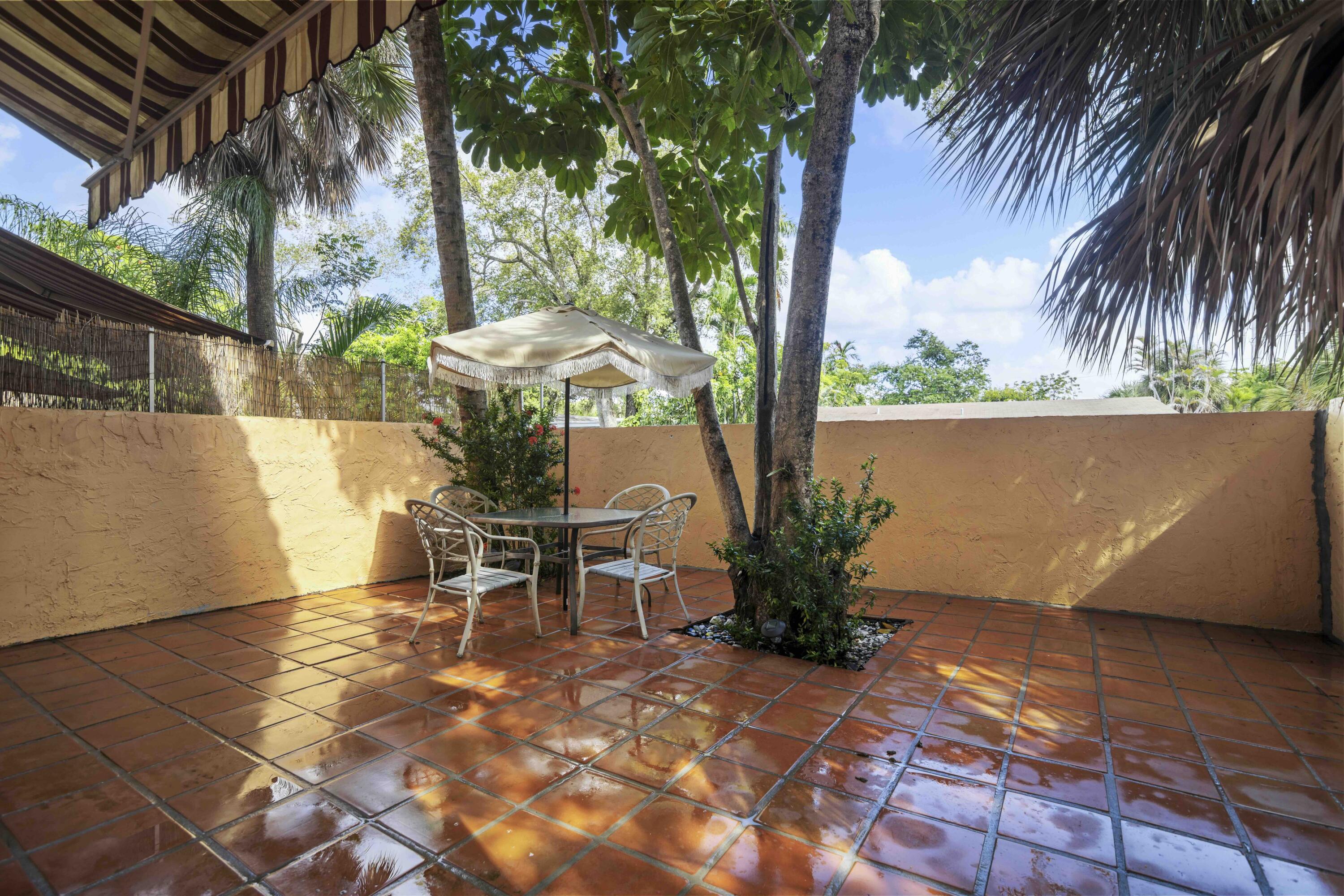1545 Miami Road Fort Lauderdale, FL 33316 - Photo 37 of 39 a view of a patio with a table and chairs under an umbrella