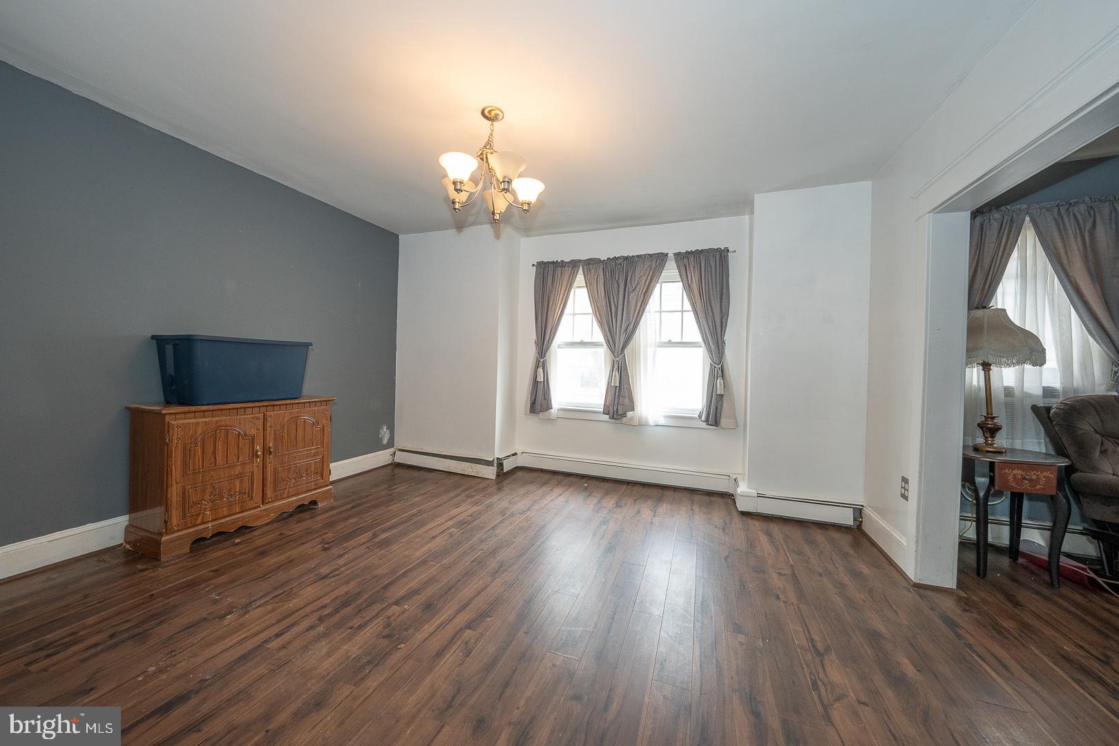 22 Delmont Road Newtown Square, PA 19073 - Photo 11 of 35 an empty room with wooden floor chandelier and windows