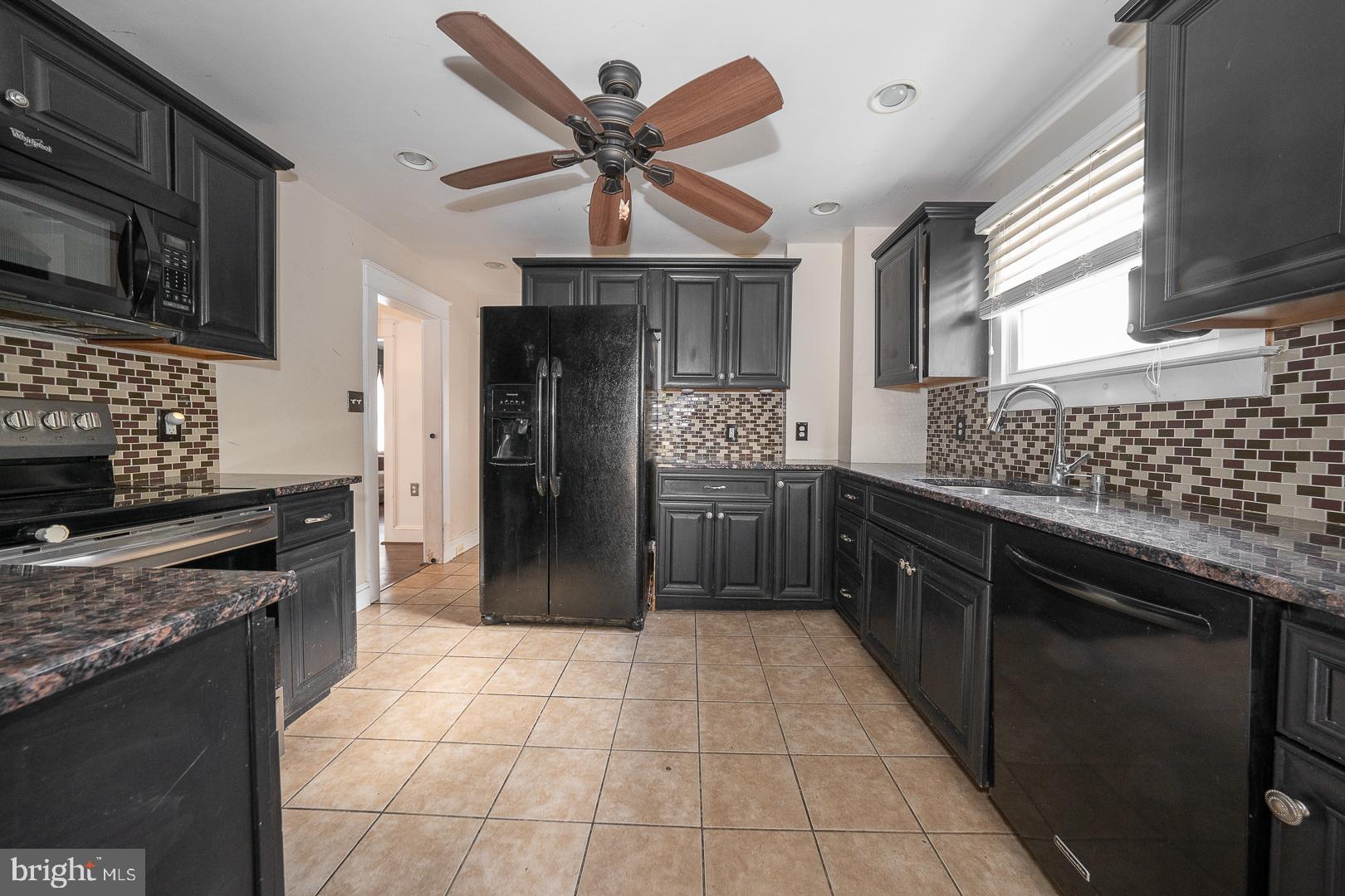 22 Delmont Road Newtown Square, PA 19073 - Photo 14 of 35 a kitchen with stainless steel appliances granite countertop a stove sink and cabinets