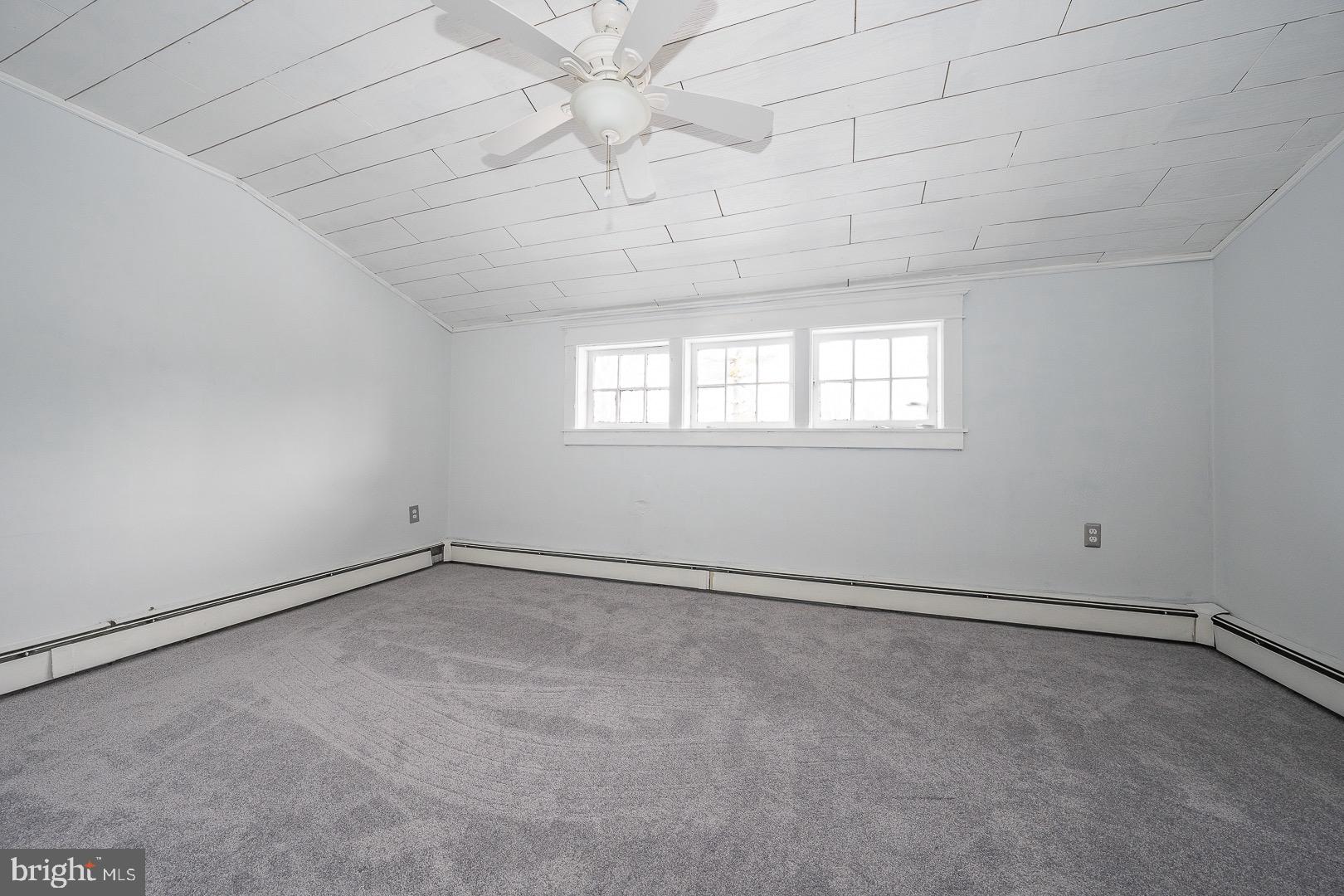 22 Delmont Road Newtown Square, PA 19073 - Photo 30 of 35 an empty room with chandelier fan and windows