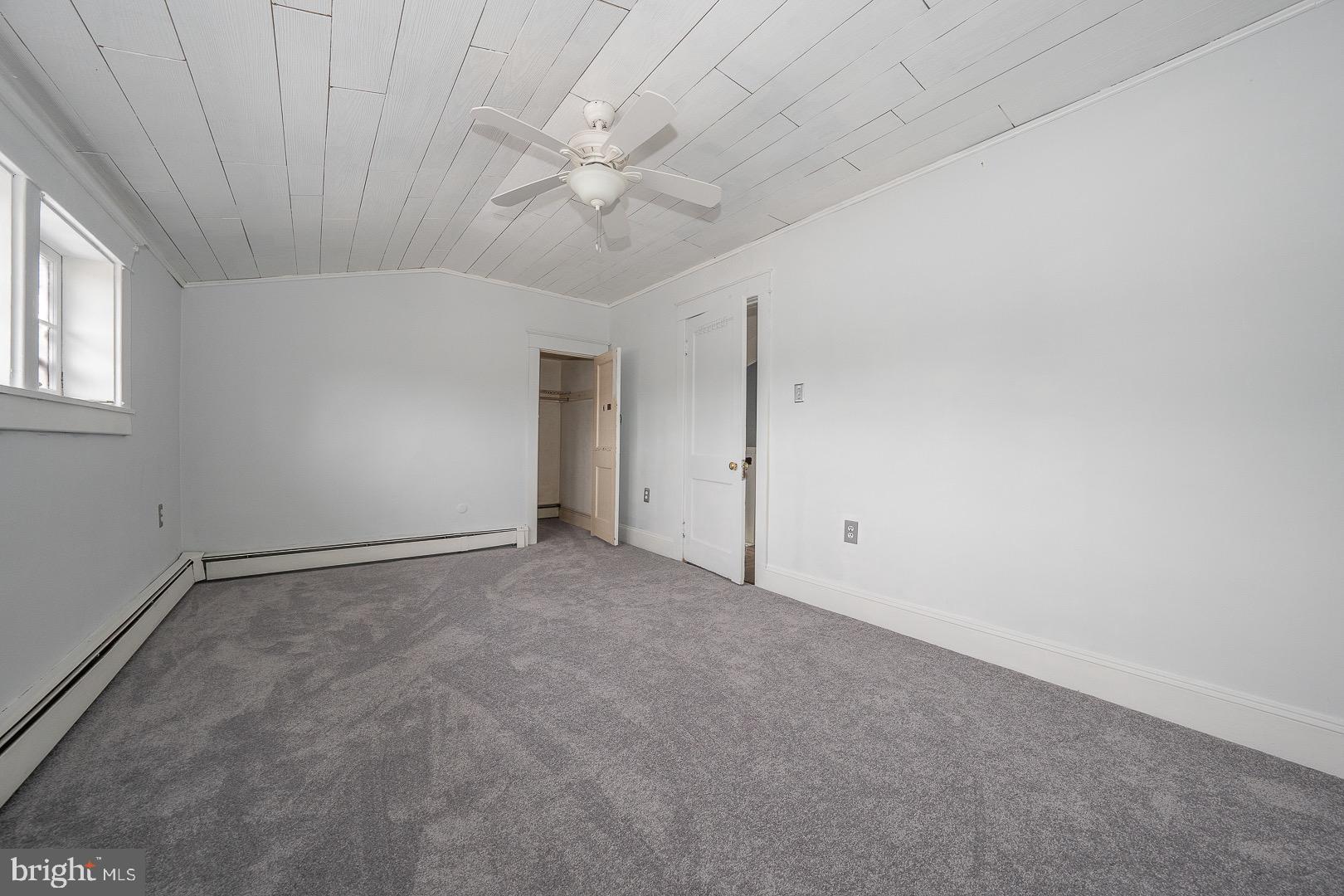 22 Delmont Road Newtown Square, PA 19073 - Photo 32 of 35 an empty room with a chandelier fan and windows