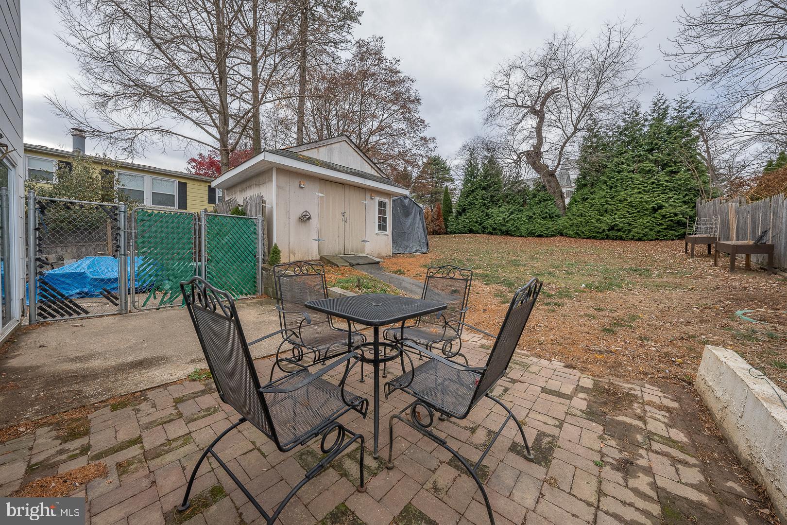 22 Delmont Road Newtown Square, PA 19073 - Photo 35 of 35 a view of backyard with table and chairs and wooden fence