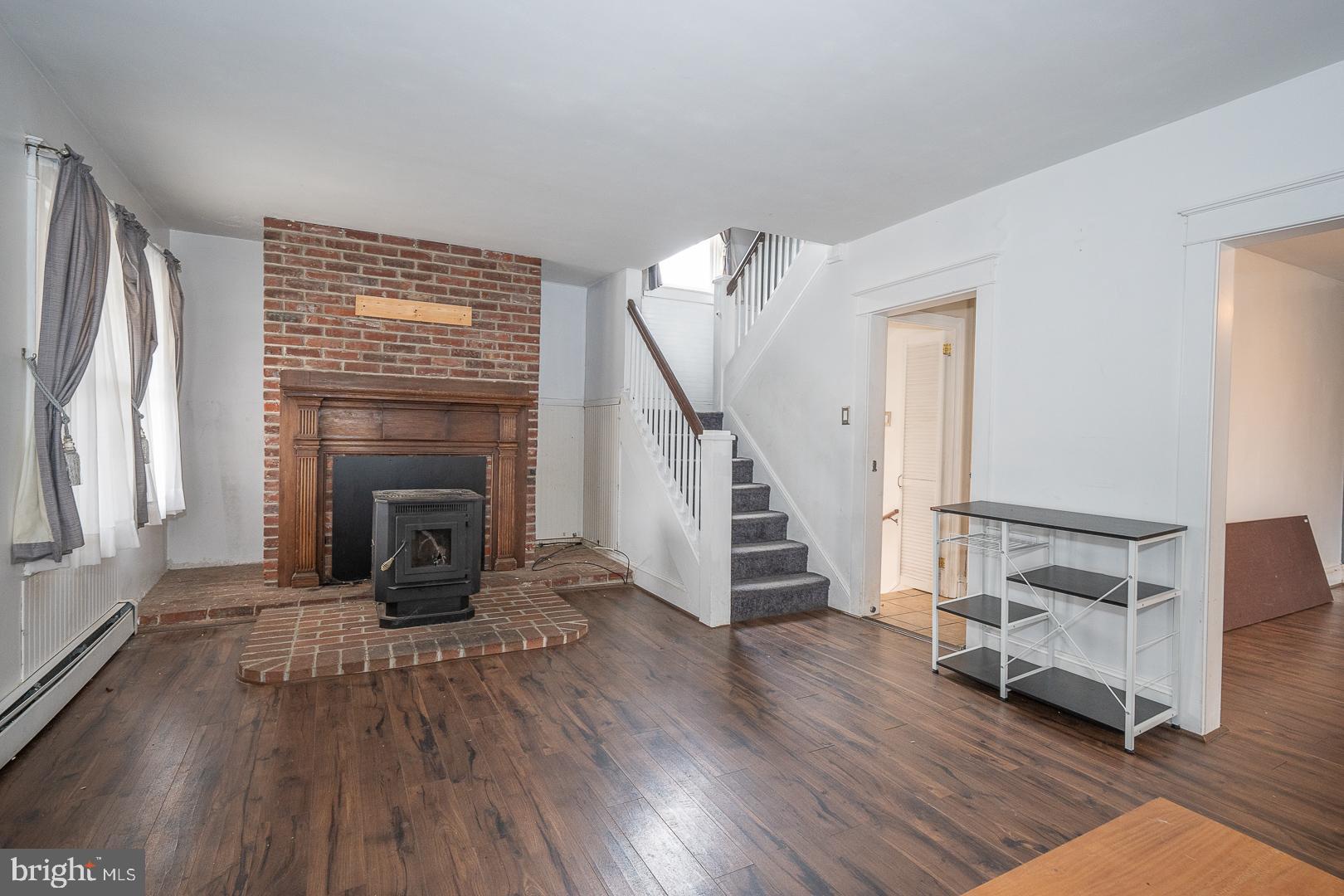 22 Delmont Road Newtown Square, PA 19073 - Photo 5 of 35 a view of a livingroom with wooden floor and a fireplace