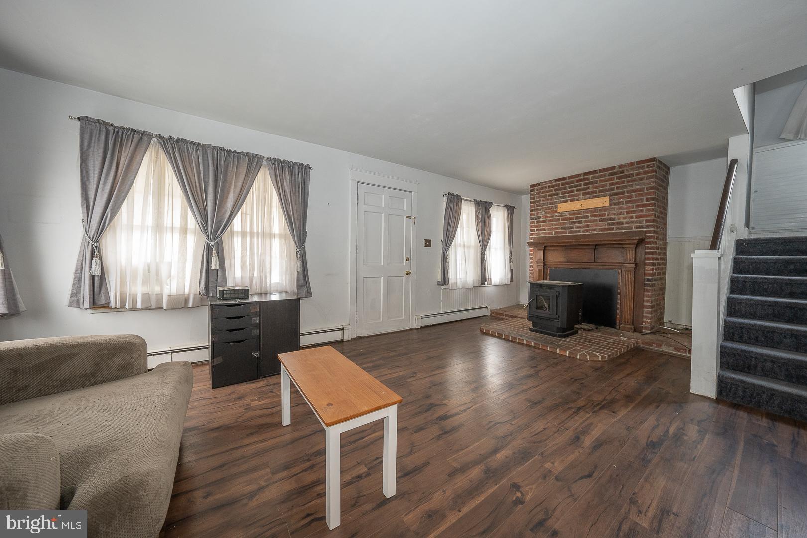 22 Delmont Road Newtown Square, PA 19073 - Photo 7 of 35 a view of empty room with wooden floor and fireplace