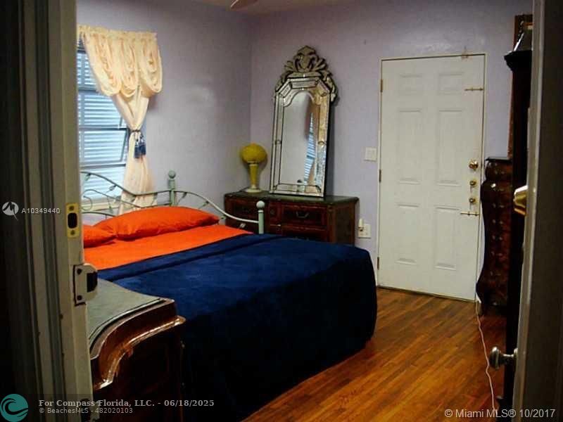 9324 Abbott Avenue Surfside, FL 33154 - Photo 11 of 33 a bedroom with a bed and a mirror on the dresser