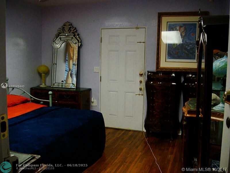 9324 Abbott Avenue Surfside, FL 33154 - Photo 12 of 33 a living room with furniture and a mirror