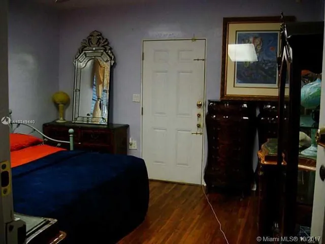 a living room with furniture and a mirror