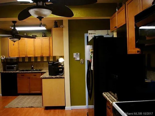 a kitchen with a refrigerator and a stove