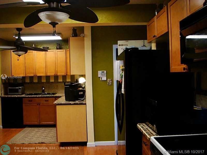 9324 Abbott Avenue Surfside, FL 33154 - Photo 15 of 33 a kitchen with a sink and cabinets