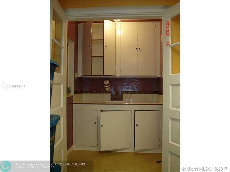 9324 Abbott Avenue Surfside, FL 33154 - Photo 17 of 33 a bathroom with a sink and a mirror