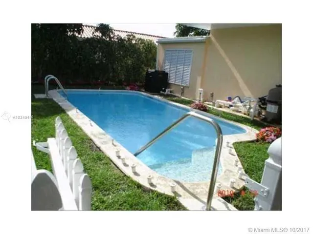 a view of a backyard with sitting area