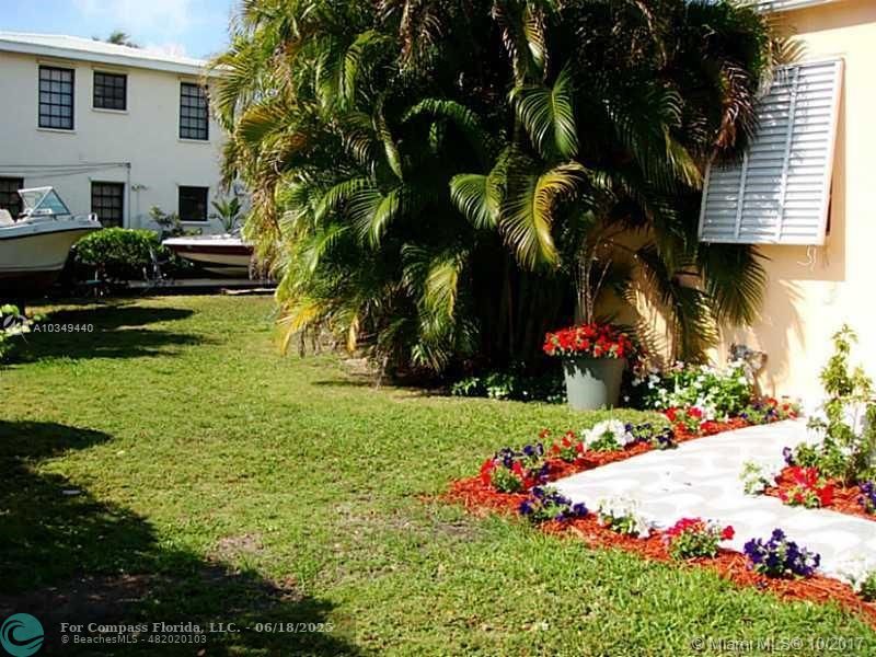 9324 Abbott Avenue Surfside, FL 33154 - Photo 4 of 33 a front view of a house with a yard