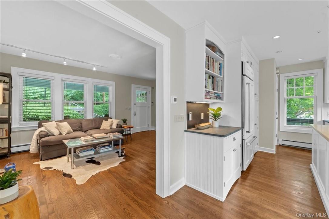 28 Inningwood Road Ossining, NY 10562 - Photo 8 of 37 Kitchen with light hardwood / wood-style floors, white cabinetry, baseboard heating, and track lighting