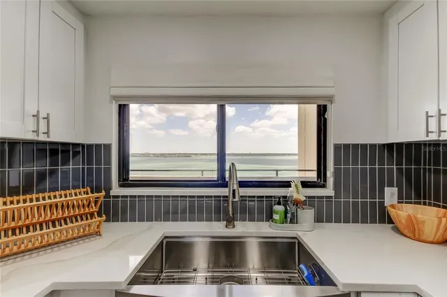 a kitchen with a sink and a large window