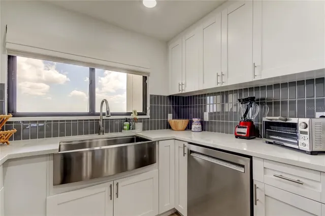 a kitchen with stove a sink and cabinets