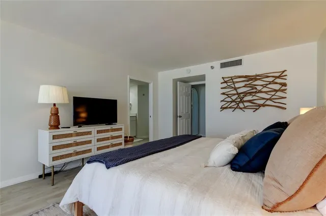 a bedroom with a bed and a flat screen tv