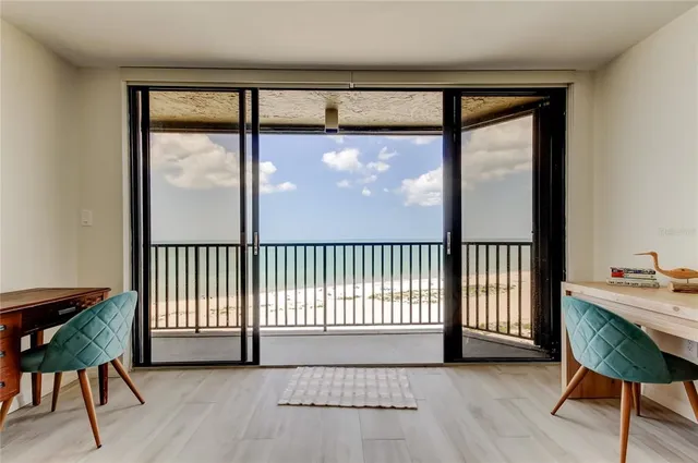 a view of a room with furniture and a window