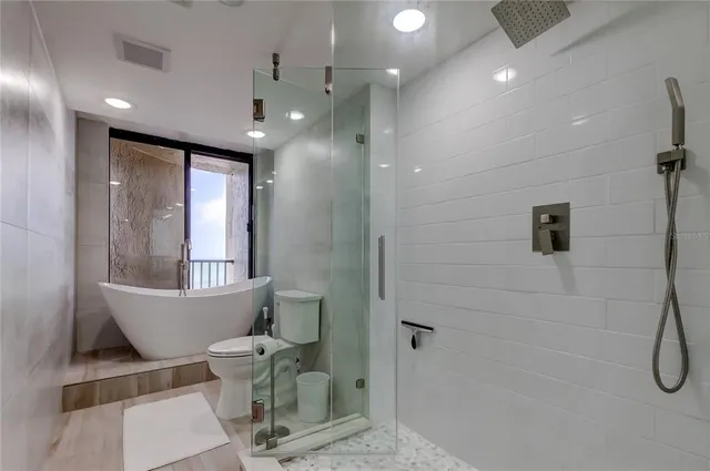 a bathroom with a toilet and a shower