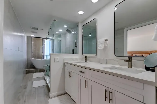 a bathroom with a double vanity sink mirror and toilet
